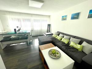 a living room with a couch and a table at Ferienwohnung Seehas am Bodensee in Friedrichshafen