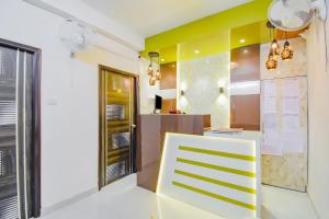 a room with a yellow and white wall at Hotel O Royal Palace in Kolkata +28 photos