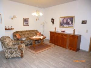 a living room with a couch and a table at Ferienwohnung Im Vierseitenhof in Annaberg-Buchholz