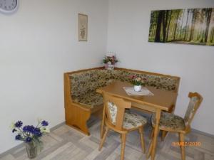 a table and a couch with a table and chairs at Ferienwohnung Im Vierseitenhof in Annaberg-Buchholz +9 photos