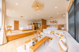 a bedroom with two beds and a living room at U AND ME 6395 DOICHANG in Ban Huai Khai