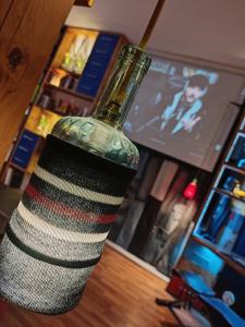 a glass bottle sitting on top of a table at Unique Penthouse with Home Cinema, Panoramic Views & Eco-Chic Design in London +23 photos