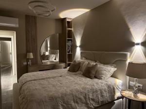 a bedroom with a large bed and a mirror at New Penthouse, free Beach, pools, and privat roof in Sharm El Sheikh