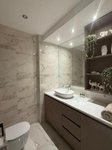 a bathroom with a sink and a toilet and a mirror at New Penthouse, free Beach, pools, and privat roof in Sharm El Sheikh +31 photos