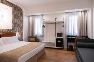 a hotel room with a bed and a desk at Hotel Dei Congressi in Rome +44 photos