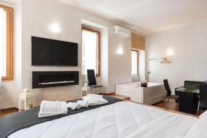 a bedroom with a large bed with a tv on the wall at Bellavista Suite 8 Piazza del Popolo in Rome