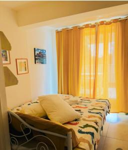 a bedroom with a bed with a curtain and a window at PURA B&b in Noicattaro