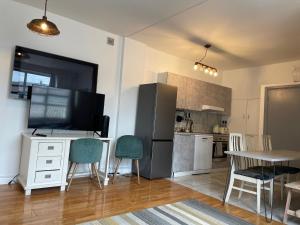 a kitchen with a table and chairs and a television at Warehouse Conversion Flat in London +6 photos