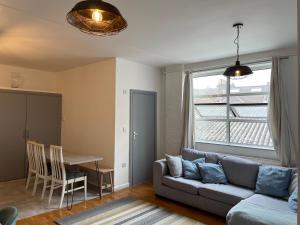 a living room with a couch and a table at Warehouse Conversion Flat in London