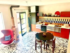 a kitchen with a table and chairs and a stove at Loft Stintino in Stintino
