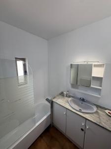 a bathroom with a sink and a mirror and a shower at Dona Ana Beach - Dream Flat in Lagos