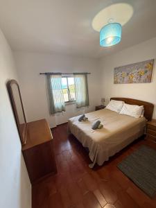 a bedroom with a large bed and a blue light at Dona Ana Beach - Dream Flat in Lagos