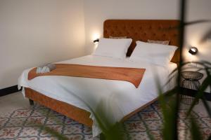 a bedroom with a large bed with white sheets and pillows at Studio Matteotti in Cefalù