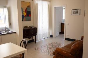 a living room with a couch and a table at Studio Matteotti in Cefalù +10 photos