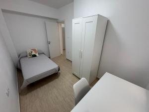 a small room with a chair and a cabinet at apartamento san urbano in Almería