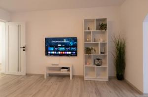 a living room with a flat screen tv on a wall at Focalize Apartament in Buzau