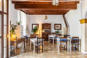 a dining room with tables and chairs at Can Busquets - Tramuntana Suite in Banyalbufar +30 photos