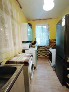 a kitchen with a sink and a refrigerator at Hostel 555 by VL in Alaverdi +20 photos