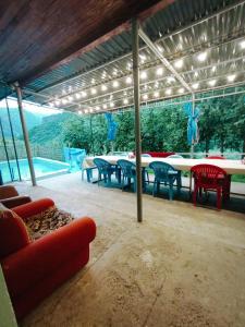 a patio with a table and chairs and a pool at Hostel 555 by VL in Alaverdi