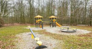a playground with two play equipment in a park at Ferienhaus Marie 125 in Bad Arolsen