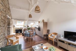 カンカルにあるRêve Emeraude - 100m de la Plageのテーブルと椅子のあるキッチンとリビングルーム +7枚の写真