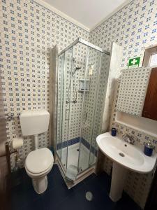 a bathroom with a shower and a toilet and a sink at Dona Ana Beach - Dream Flat in Lagos +27 photos