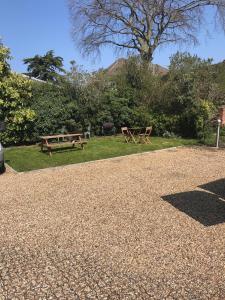 two picnic tables in a park with a tree at Flat 14 Helena House 1-Bed Sleeps 3 Parking in Reading
