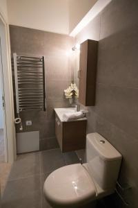 a bathroom with a toilet and a sink at Pearl Mansions in Nikiana +95 photos