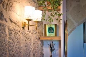 a room with a candle on a wall at La suite du Duché in Uzès +14 photos