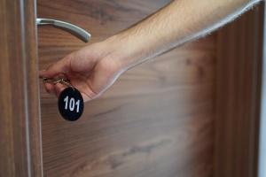 a persons hand unlocking a door with a lock at Skopje Horizon Hotel in Skopje