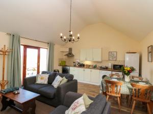 a living room with a couch and a table at Partridge Cottage in Filey
