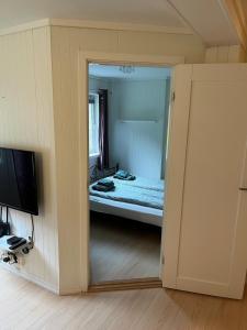a view of a bedroom with a bed and a television at Spacious apartment in Kristiansand with EV Station in Kristiansand