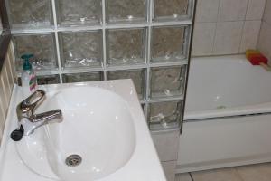 a bathroom with a sink and a bath tub at Spacious apartment in Kristiansand with EV Station in Kristiansand