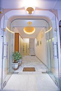 an entrance to a hallway with a glass door at Pioneer Excelsior Rooms in Paralia Katerinis