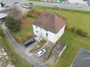 an aerial view of a white house with two cars at OF01 Große Wohnung - 3 Schlafzimmer mit 8 Einzelbetten - LS Crewcomfort - weitere Unterkünfte für Monteure und Handwerker verfügbar in Ofterdingen