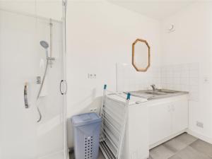 a white bathroom with a sink and a shower at Vue mer - 50 m du port - Maison pour 6 - Jardin in Le Croisic +19 photos