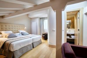 Ένα ή περισσότερα κρεβάτια σε δωμάτιο στο Nexus Santa María Luxury Apartamentos