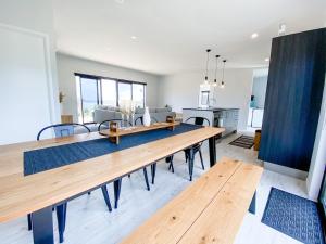 a dining room and living room with a wooden table at Quiet Escape in Karikari Peninsula