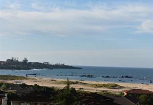 a beach with a group of people in the water at Atico in Noja Helgueras in Noja