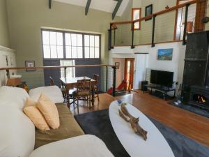a living room with a couch and a fireplace at Zoar Chapel in Kilgetty