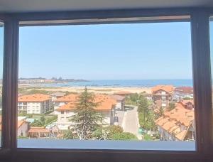 a view of a city from a window at Atico in Noja Helgueras in Noja +5 photos
