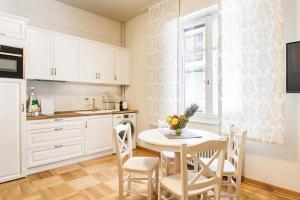 a kitchen and dining room with a table and chairs at Restored Historic APT in Plaka,Under the Acropolis in Athens
