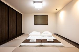 a bedroom with three beds in a room at Irodori Hotel AKEBONO in Fukuoka +33 photos