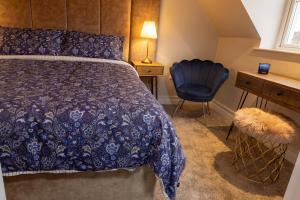 a bedroom with a bed and a desk and a chair at Sarahs Home Away from Home Luxury Apartment in Ennis