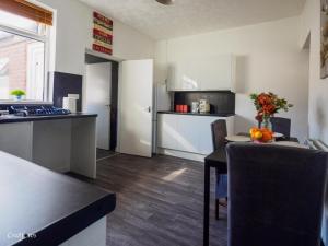 a kitchen with a table and a counter top at 12 Cornwallis Lodge Family Room 1 in Stoke on Trent