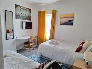 a bedroom with a bed and a desk with a computer at 12 Cornwallis Lodge Family Room 1 in Stoke on Trent