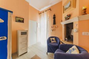 a living room with a blue chair and a fireplace at Casa a *POLIGNANO* con [Affaccio sul Mare] in Polignano a Mare +13 photos