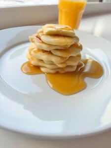 a stack of pancakes on a plate with syrup at Holiday Inn Express Manchester City Centre Arena by IHG in Manchester