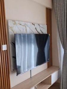 a flat screen tv hanging on a wall at Artesano Park View Furnished Apartment in Nairobi