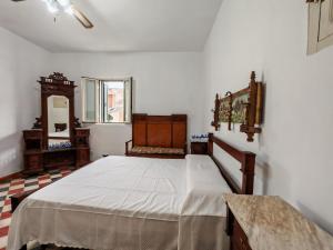 a bedroom with a large bed and a mirror at Casa Gelsomino by Holiday World in Donnalucata